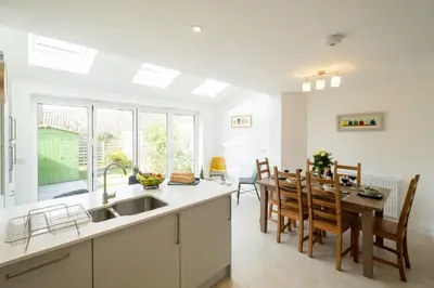 a kitchen and dining room with a table and chairs at Pinky Cottage in Aldeburgh