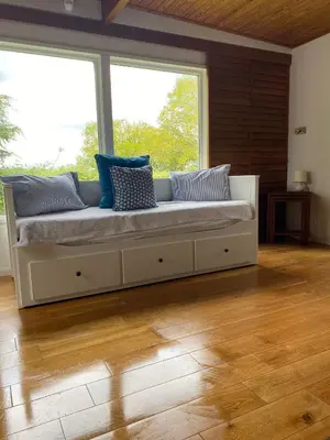a couch in a room with a large window at Wood Place in Diss