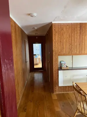 a room with wooden walls and a table and a window at Wood Place in Diss