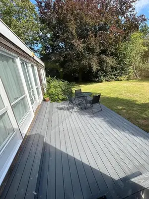 a wooden deck with a table and chairs on it at Wood Place in Diss