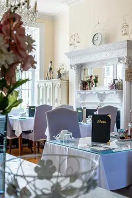a dining room with a table with a laptop on it at Hamiltons Boutique Hotel in Southend-on-Sea