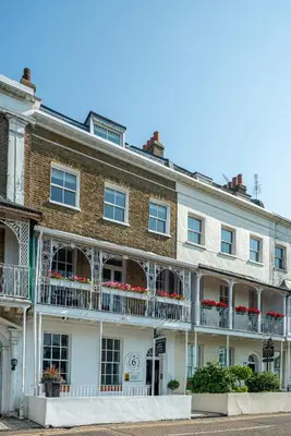 a large brick building with balconies on a street at Hamiltons Boutique Hotel in Southend-on-Sea