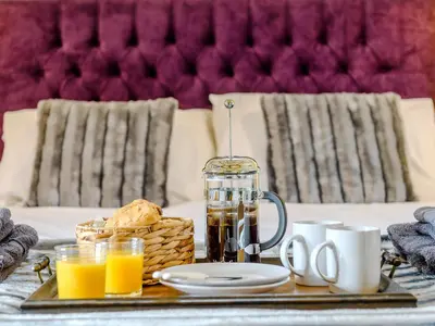 a table with a tray of orange juice and bread at Laurel Barn in Ashwellthorpe