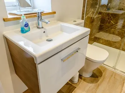 a bathroom with a sink and a toilet at Blackwell Barn in Raydon