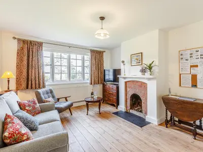 a living room with a couch and a fireplace at Mark Farmhouse in Bradwell on Sea