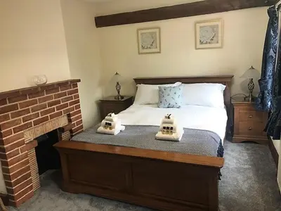 a bedroom with a bed with two towels on it at Little Easton Manor in Great Easton