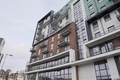 a tall building with many windows at Toothbrush Apartments - Ipswich Waterfront South - Avalon Court in Ipswich
