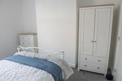a bedroom with a bed and a white cabinet at Toothbrush Apartments - Central Ipswich - Fore St in Ipswich