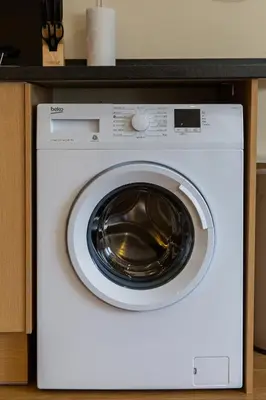 a white washing machine sitting in a kitchen at 2 Bedroom Penthouse, Clockhouse, Hoddessdon in Hoddesdon
