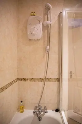 a shower in a bathroom with a sink at 2 Bedroom Penthouse, Clockhouse, Hoddessdon in Hoddesdon