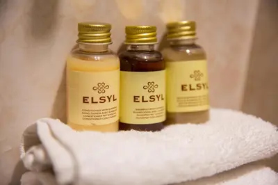 three bottles of essential oils sitting on a towel at 2 Bedroom Penthouse, Clockhouse, Hoddessdon in Hoddesdon