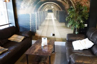 a room with couches and a table and a tunnel at The North Hill Hotel, Colchester in Colchester