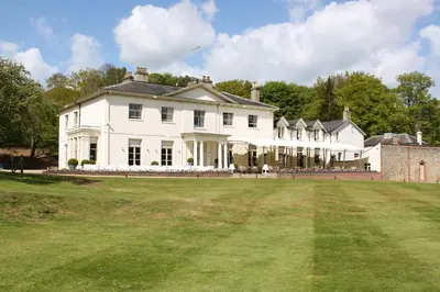 a large white house with a large yard at Milsoms Kesgrave Hall in Ipswich