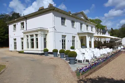 a white house with white tables and chairs at Milsoms Kesgrave Hall in Ipswich