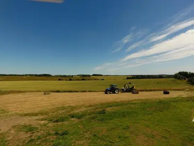 a tractor in the middle of a field at 1 Bed in Wickhambrook oc-tosh in Wickhambrook