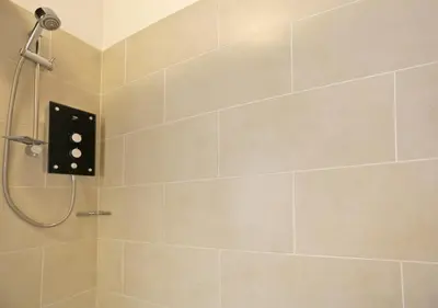 a bathroom with a shower with a shower head at High Tide in Aldeburgh