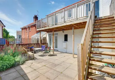 a patio with a deck and a stair case at High Tide in Aldeburgh