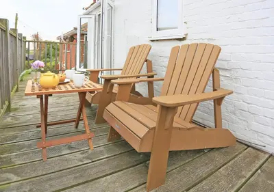 two chairs and a table on a patio at High Tide in Aldeburgh