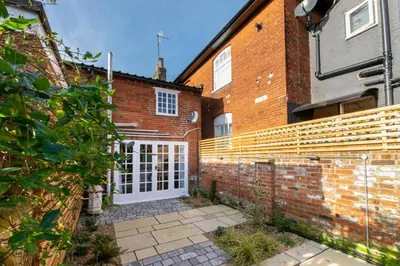 a brick house with a white door and a brick wall at 1 Bed in Woodbridge oc-jsm in Woodbridge