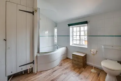 a bathroom with a tub and a toilet and a sink at 1 Bed in Woodbridge oc-jsm in Woodbridge