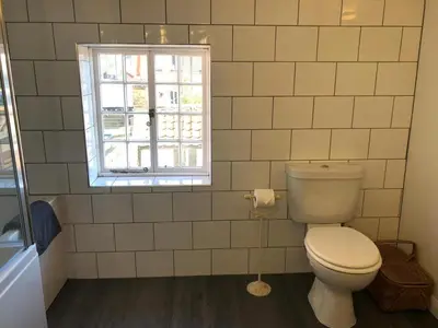 a bathroom with a toilet and a window at 1 Bed in Woodbridge oc-jsm in Woodbridge