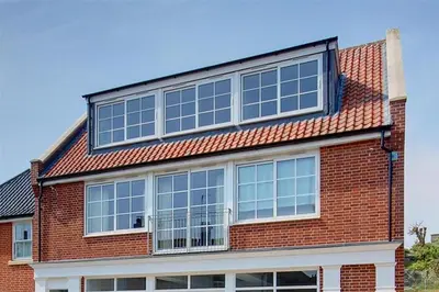 a red brick building with a lot of windows at 1 Bed in Aldeburgh oc-sld in Aldeburgh