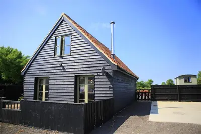 a small house with a black fence in front of it at 1 Bed in Sibton oc-sfbor in Sibton