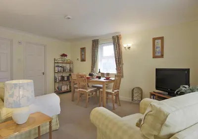 a living room with a couch and a table at 2 Coastguard Court in Aldeburgh