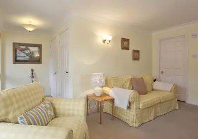 a living room with two couches and a table at 2 Coastguard Court in Aldeburgh