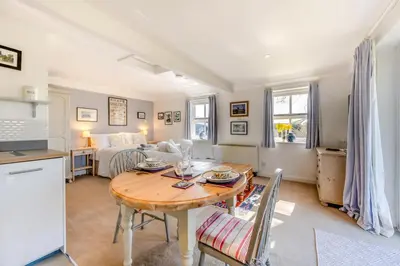 a kitchen and a living room with a table and a couch at 1 Bed in Snape oc-sfgcs in Snape