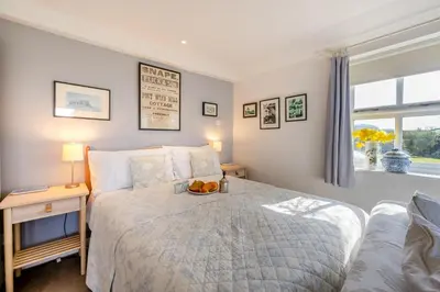 a bedroom with a bed with a bowl of fruit on it at 1 Bed in Snape oc-sfgcs in Snape