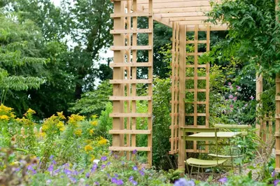 a wooden trellis in the middle of a garden at 1 Bed in Wilby oc-wlo in Wilby