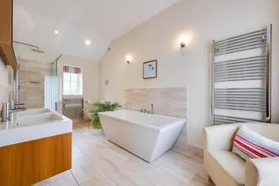 a large bathroom with a large tub and a sink at 1 Bed in Wilby oc-wlo in Wilby