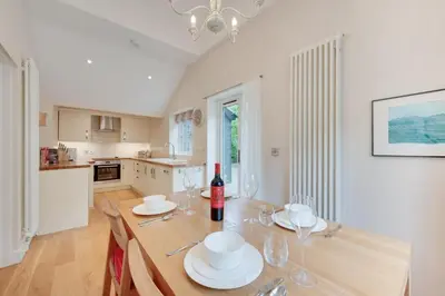 a dining room with a table with wine glasses at 1 Bed in Wilby oc-wlo in Wilby