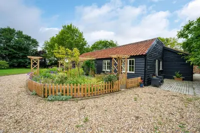 a small house with a garden in front of it at 1 Bed in Wilby oc-wlo in Wilby