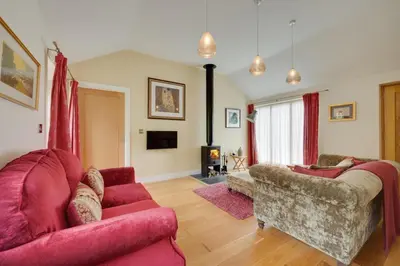 a living room with two red couches and a fireplace at 1 Bed in Wilby oc-wlo in Wilby