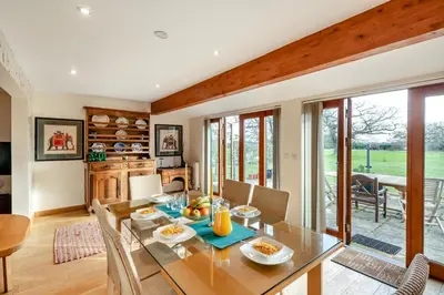 a dining room with a glass table and chairs at 1 Bed in Woodbridge oc-meb in Sudbourne