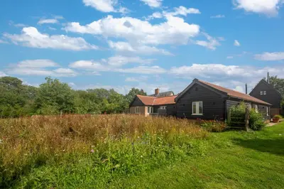 a house in a field next to a house at 1 Bed in Middleton oc-stbc in Middleton