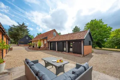 an outdoor patio with a table and a building at 1 Bed in Halesworth oc-bbb in Bramfield
