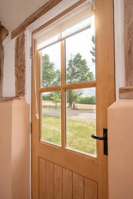 a wooden door with a window in a room at 1 Bed in Halesworth oc-bbb in Bramfield