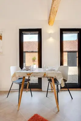 a dining room with a wooden table and chairs at 1 Bed in Halesworth oc-bbb in Bramfield