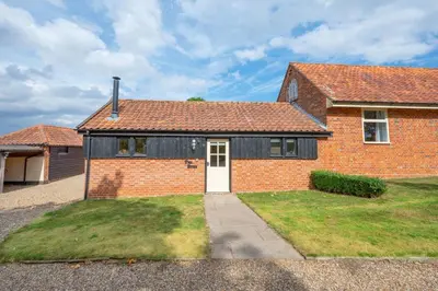 a red brick house with a white door at 1 Bed in Halesworth oc-bbb in Bramfield