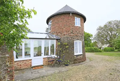 a brick house with a round window and a turret at 1 Bed in Wickham Market oc-samp in Wickham Market