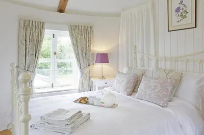 a white bed with a tray of food on it at 1 Bed in Wickham Market oc-samp in Wickham Market