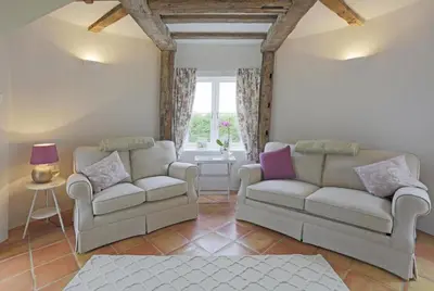 a living room with two couches and a window at 1 Bed in Wickham Market oc-samp in Wickham Market