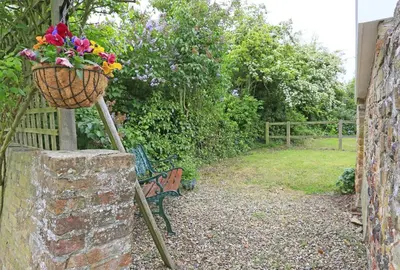 a bench with a basket of flowers on it at 1 Bed in Wickham Market oc-samp in Wickham Market