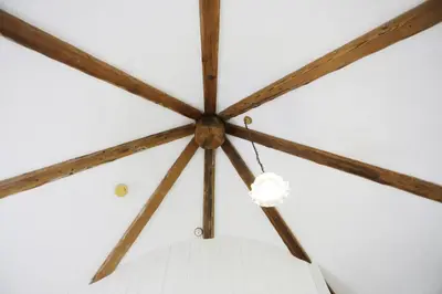 a ceiling with wooden beams and a white ball at 1 Bed in Wickham Market oc-samp in Wickham Market