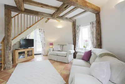 a living room with a white couch and a tv at 1 Bed in Wickham Market oc-samp in Wickham Market