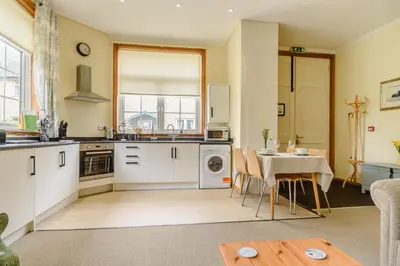 a kitchen with a table and a dining room at 1 Bed in Sizewell oc-gdnf in Sizewell