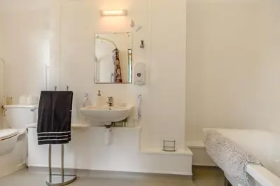 a bathroom with a sink and a toilet and a mirror at 1 Bed in Sizewell oc-gdnf in Sizewell